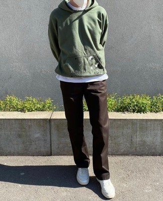 White and Red Leather Low Top Sneakers Outfits For Men: An olive print hoodie and dark brown chinos have become true wardrobe must-haves for most men. White and red leather low top sneakers are a savvy idea to round off this outfit.