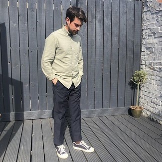 Black Chinos Outfits: Putting together an olive long sleeve shirt with black chinos is a smart pick for an off-duty yet stylish outfit. To give your overall ensemble a more laid-back feel, add black and white canvas low top sneakers to the equation.