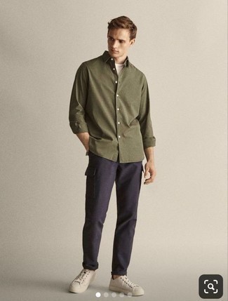 Olive Long Sleeve Shirt Outfits For Men: An olive long sleeve shirt looks especially great when combined with navy cargo pants. White canvas low top sneakers pull the getup together.