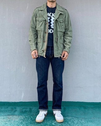 Military Jacket Outfits For Men: The versatility of a military jacket and navy jeans ensures they'll be on regular rotation. Dress down your look by rounding off with white and navy canvas low top sneakers.
