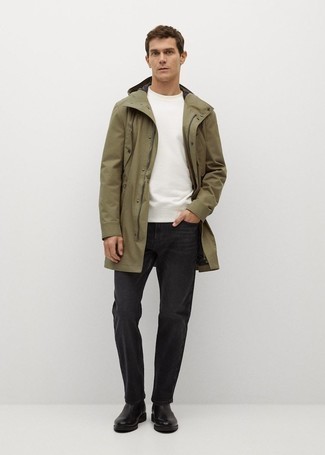 Olive Raincoat Outfits For Men: If the setting allows a casual outfit, go for an olive raincoat and charcoal jeans. And if you need to instantly level up your look with one single piece, introduce black leather chelsea boots to the mix.