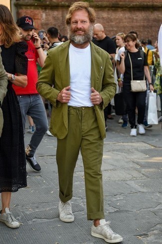 Olive Suit Outfits After 40: This pairing of an olive suit and a white crew-neck t-shirt is a winning option when you need to look on-trend but have no extra time. Serve a little mix-and-match magic by slipping into white canvas low top sneakers. A reliable option combination appropriate for gentlemen in their forties.