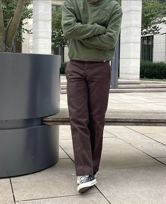 Olive Sweatshirt Outfits For Men: For a safe off-duty option, you can't go wrong with this combo of an olive sweatshirt and dark brown chinos. If not sure as to what to wear on the footwear front, stick to black and white canvas low top sneakers.