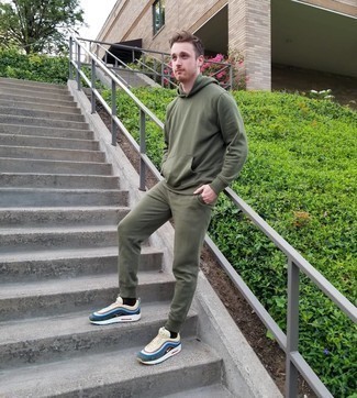 Olive Track Suit Outfits For Men: To achieve an off-duty outfit with an edgy spin, you can easily opt for an olive track suit. If you want to immediately polish off this outfit with one single piece, why not complete this ensemble with multi colored athletic shoes?