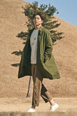 Men's Olive Trenchcoat, White and Black Print Crew-neck T-shirt, Brown Chinos, White Canvas Slip-on Sneakers