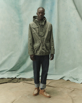 Olive Windbreaker Outfits For Men: Marry an olive windbreaker with charcoal jeans to pull together an interesting and modern-looking relaxed casual ensemble. With shoes, go for something on the more elegant end of the spectrum and finish off your ensemble with tan leather desert boots.