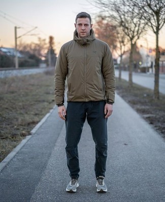 Olive Windbreaker Outfits For Men: This combination of an olive windbreaker and navy chinos is a great look for when it's time to go off-duty. Complement your ensemble with grey athletic shoes to immediately bump up the appeal of this getup.
