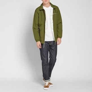 Brown Canvas Low Top Sneakers Outfits For Men: Why not try pairing an olive windbreaker with charcoal jeans? Both pieces are very comfortable and look cool combined together. Complete your outfit with brown canvas low top sneakers and the whole outfit will come together quite nicely.
