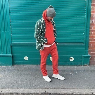 Red and Black Track Suit Outfits For Men: This combination of a red and black track suit and a dark green open cardigan is a safe go-to for an effortlessly dapper getup. Let your styling chops really shine by finishing your ensemble with a pair of white canvas high top sneakers.