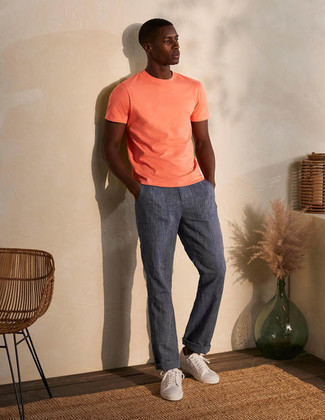 Charcoal Linen Chinos Outfits: One of the best ways for a man to style out an orange crew-neck t-shirt is to combine it with charcoal linen chinos for a laid-back ensemble. A pair of white canvas low top sneakers can integrate effortlessly within plenty of combinations.
