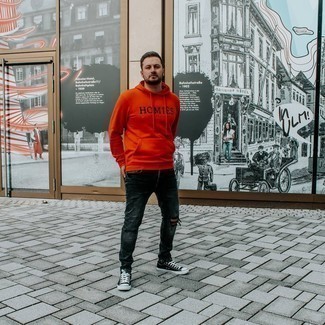 Orange Print Hoodie Outfits For Men: Try pairing an orange print hoodie with charcoal ripped jeans for a laid-back outfit with an edgy spin. For shoes, follow a classier route with black and white canvas low top sneakers.