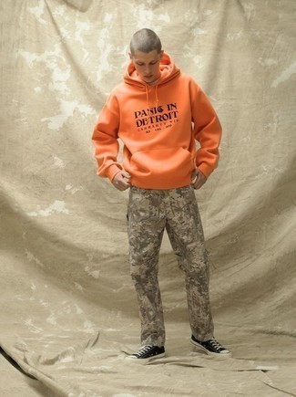 Orange Print Hoodie Outfits For Men: For an off-duty ensemble, pair an orange print hoodie with grey print chinos — these pieces play perfectly well together. Black and white canvas low top sneakers pull the outfit together.