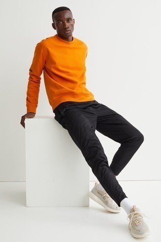 Orange Sweatshirt Outfits For Men: An orange sweatshirt and black chinos are among the key pieces in any guy's versatile off-duty arsenal. Wondering how to finish off? Complete this ensemble with a pair of beige athletic shoes to spice things up.