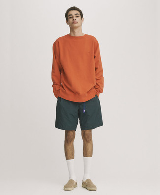 Beige Canvas Slip-on Sneakers Outfits For Men: An orange sweatshirt and dark green sports shorts are a great combo to have in your casual styling routine. Introduce a pair of beige canvas slip-on sneakers to the mix to completely spice up the ensemble.