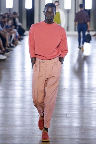 Burgundy Suede Desert Boots Outfits: This outfit clearly illustrates it is totally worth investing in such smart menswear pieces as an orange sweatshirt and pink dress pants. For something more on the daring side to complete your look, introduce a pair of burgundy suede desert boots to this getup.