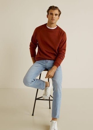 Orange Sweatshirt Outfits For Men: Why not pair an orange sweatshirt with light blue jeans? As well as very practical, both items look great when paired together. We're loving how a pair of white canvas low top sneakers makes this outfit complete.