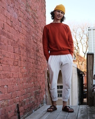 Tobacco Leather Sandals Outfits For Men: This combination of an orange sweatshirt and white sweatpants is a safe and very fashionable bet. Send an otherwise classic ensemble down a more informal path by slipping into a pair of tobacco leather sandals.