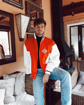 Orange Varsity Jacket Outfits For Men: To don a casual menswear style with a clear fashion twist, pair an orange varsity jacket with light blue jeans.