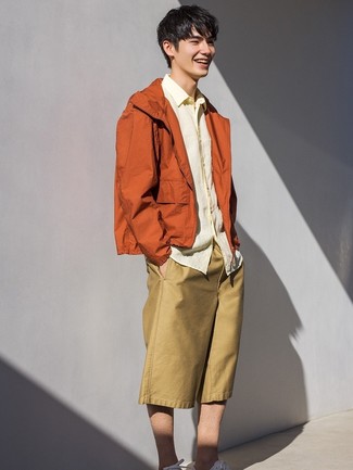 Yellow Windbreaker Outfits For Men: For a look that's pared-down but can be manipulated in a ton of different ways, choose a yellow windbreaker and tan shorts. White low top sneakers are a tested footwear style here that's also full of personality.