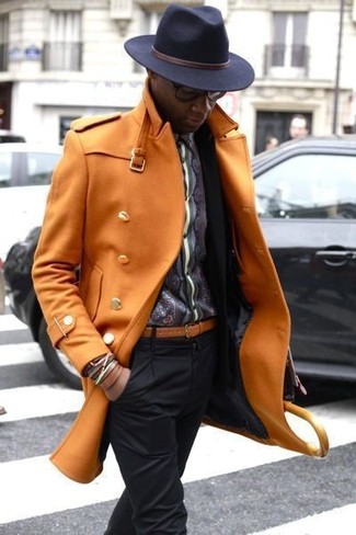 Go for a smart outfit in an orange overcoat and black dress pants.