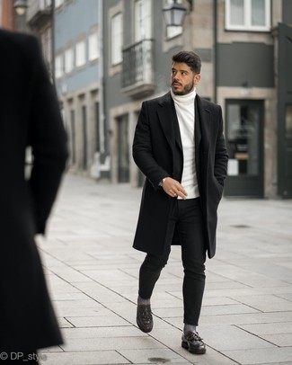 White Turtleneck Outfits For Men: Consider wearing a white turtleneck and black skinny jeans if you seek to look casual and cool without exerting much effort. Play down the casualness of this look by slipping into burgundy leather tassel loafers.