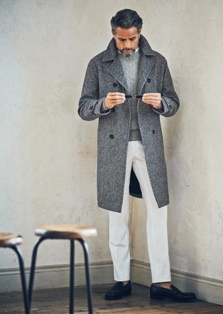 Charcoal Cable Sweater Outfits For Men: We're loving the way this combination of a charcoal cable sweater and white dress pants immediately makes any guy look smart and refined. Our favorite of an infinite number of ways to finish off this outfit is with a pair of black leather loafers.