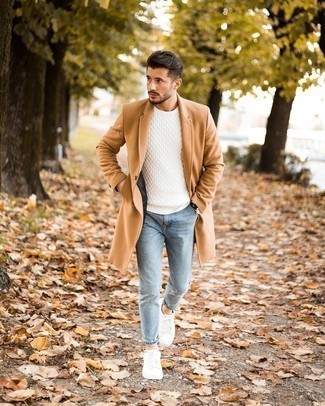 Camel Overcoat Warm Weather Outfits: To achieve a relaxed look with a clear fashion twist, you can easily go for a camel overcoat and light blue skinny jeans. Avoid looking overdressed by finishing with white canvas low top sneakers.