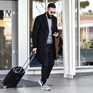 Black Suitcase Outfits For Men: If you don't take fashion too seriously, go for casual urban style in a black overcoat and a black suitcase. For something more on the casual and cool end to round off your look, add a pair of grey athletic shoes to the mix.