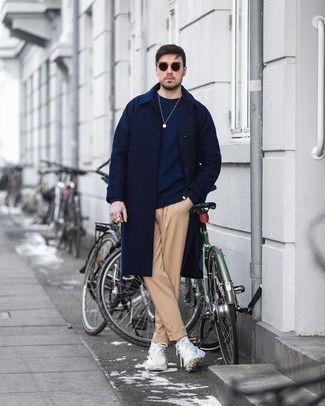 Navy Crew-neck Sweater Cold Weather Outfits For Men: A navy crew-neck sweater and khaki chinos married together are a match made in heaven for those dressers who love laid-back and cool styles. Beige athletic shoes will bring a touch of stylish nonchalance to an otherwise standard outfit.