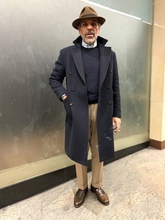 1200+ Dressy Cold Weather Outfits For Men: A black overcoat and khaki dress pants are a truly sharp getup to try. Dark brown leather loafers are a fail-safe way to add an element of stylish effortlessness to this getup.