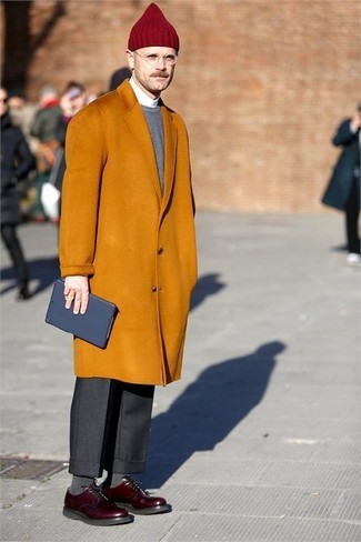 Orange Overcoat Outfits: This polished combination of an orange overcoat and black dress pants will be indisputable proof of your styling expertise. A trendy pair of burgundy leather derby shoes is the simplest way to power up your getup.