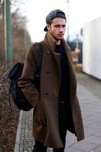 This combo of a brown overcoat and black jeans looks put together and immediately makes any gent look dapper.
