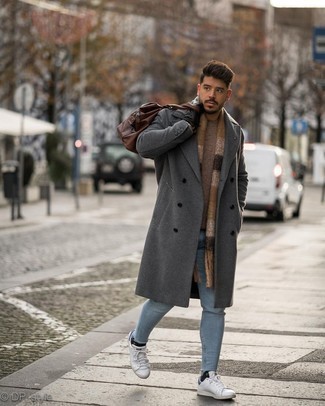 Men's Grey Overcoat, Brown Crew-neck Sweater, Light Blue Skinny Jeans, White and Navy Leather Low Top Sneakers