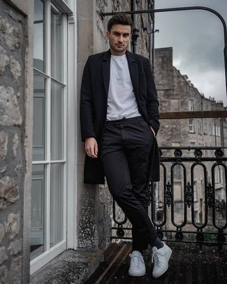 Black Overcoat Outfits: You'll be surprised at how easy it is for any guy to get dressed like this. Just a black overcoat combined with black chinos. If you need to effortlessly play down your ensemble with one piece, add white canvas low top sneakers to the equation.