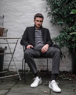 Black Overcoat Outfits: Ramp up your style game by wearing this combo of a black overcoat and charcoal chinos. White canvas low top sneakers will bring a playful touch to an otherwise standard getup.