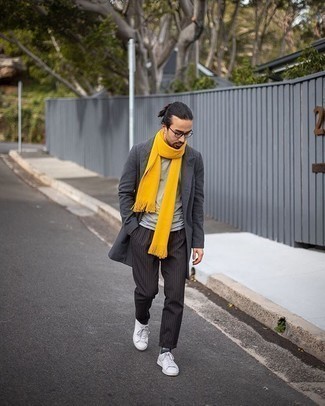 Mustard Scarf Outfits For Men: Why not opt for a charcoal overcoat and a mustard scarf? These items are very functional and will look amazing matched together. We're totally digging how a pair of white canvas low top sneakers makes this look complete.