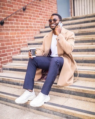 Camel Overcoat Warm Weather Outfits: This combo of a camel overcoat and navy chinos is a real lifesaver when you need to look sharp but have no time to dress up. If you need to instantly dial down this getup with footwear, why not introduce a pair of white athletic shoes to the mix?
