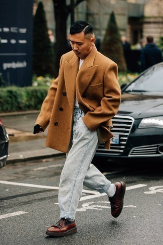 Brown Leather Derby Shoes Chill Weather Outfits: A tobacco overcoat and light blue acid wash jeans paired together are a perfect match. Brown leather derby shoes are a simple way to punch up your ensemble.
