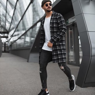 Black and White Plaid Overcoat Outfits: Go for a pared down yet cool and relaxed option by opting for a black and white plaid overcoat and charcoal ripped skinny jeans. Take a sleeker approach with footwear and complete your ensemble with black and white leather low top sneakers.
