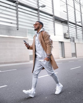 Brown Leather Backpack Outfits For Men: A camel overcoat and a brown leather backpack are a contemporary pairing that every modern gent should have in his off-duty collection. A pair of white canvas low top sneakers integrates perfectly within a ton of combos.