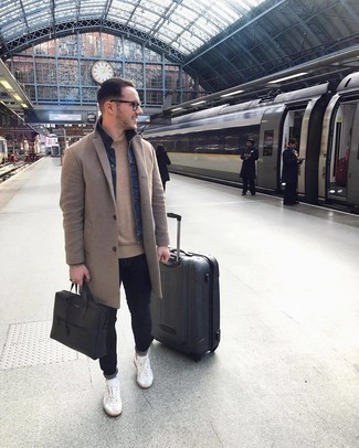 Black Suitcase Outfits For Men: This bold casual combo of a camel overcoat and a black suitcase is capable of taking on different moods depending on how it's styled. If you don't know how to finish, complete your outfit with a pair of white leather low top sneakers.