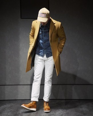 500+ Cold Weather Outfits For Men: This smart pairing of a camel overcoat and white jeans is capable of taking on different forms depending on the way you style it. Tan leather brogue boots act as the glue that brings your ensemble together.