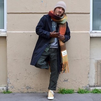 203 Winter Outfits For Men: This pairing of a navy overcoat and dark green cargo pants is the perfect base for a variety of getups. Bring a more casual vibe to by wearing a pair of mustard canvas high top sneakers. Crafting a neat combo can be a bit of a conundrum on its own. Enter extra cold temps into the equation, and the whole thing becomes even more difficult. No worries, this here is your winter inspo.