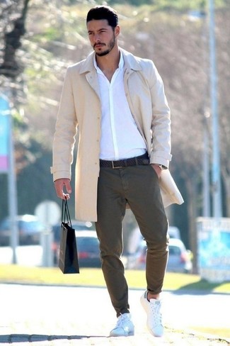 White Leather Low Top Sneakers Chill Weather Outfits For Men: A beige overcoat and olive chinos are an easy way to introduce some manly elegance into your current off-duty routine. Avoid looking overdressed by finishing off with white leather low top sneakers.