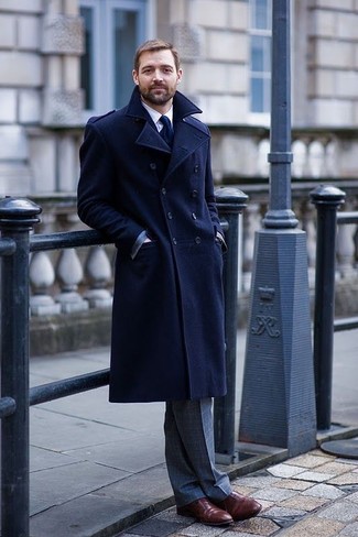 Dress for success in a navy overcoat and grey check dress pants. Burgundy leather oxford shoes pull the getup together.
