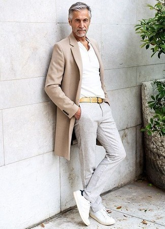 Yellow Leather Belt Outfits For Men: Exhibit your prowess in men's fashion by marrying a beige overcoat and a yellow leather belt for an urban getup. If in doubt about the footwear, go with white and black canvas low top sneakers.
