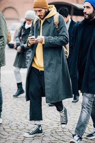 Yellow Beanie Outfits For Men: This edgy pairing of a charcoal overcoat and a yellow beanie is super easy to throw together in seconds time, helping you look amazing and prepared for anything without spending a ton of time rummaging through your closet. Complement your ensemble with a pair of charcoal high top sneakers and the whole look will come together brilliantly.