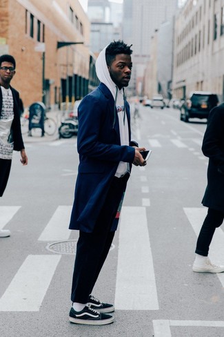 Dark Green Canvas Low Top Sneakers Outfits For Men: Try teaming a navy overcoat with navy chinos to pull together a casually classic and pulled together outfit. Feeling bold? Tone down this ensemble by finishing off with dark green canvas low top sneakers.