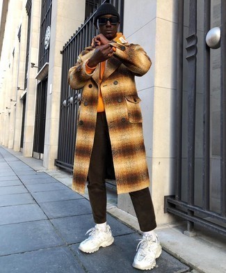Orange Overcoat Outfits: Such items as an orange overcoat and dark brown chinos are the perfect way to infuse extra sophistication into your current fashion mix. White athletic shoes will effortlessly tone down a dressy getup.