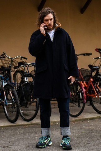 Men's Outfits 2024: Master the classic and casual ensemble in a navy overcoat and navy jeans. Add a sense of stylish nonchalance to by sporting black athletic shoes.